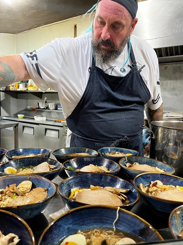 Chef Umberto preparing multiple handcrafted dishes for a private dining event in Puerto Morelos, Mexico.