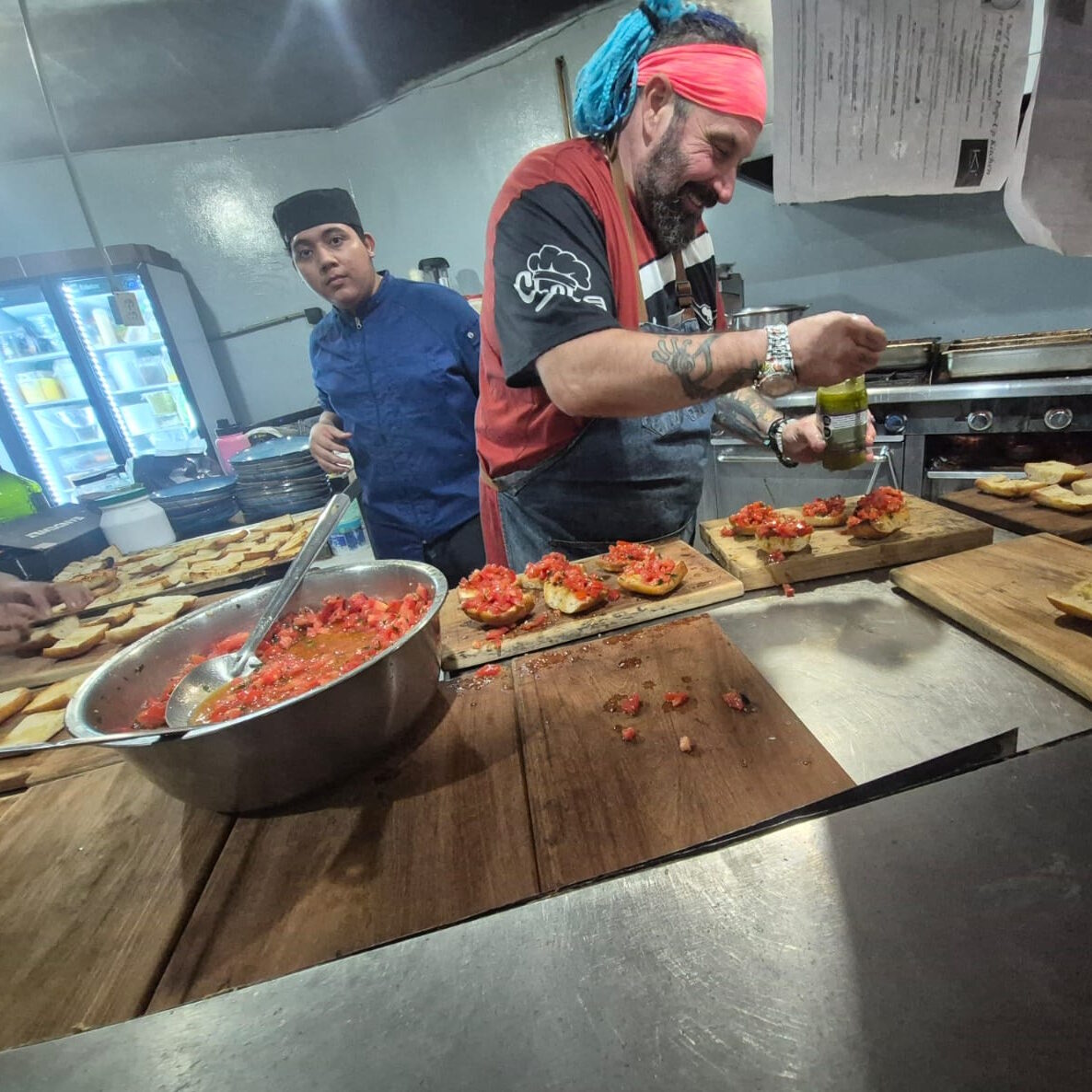 private chef happily making bruschetta in kitchen
